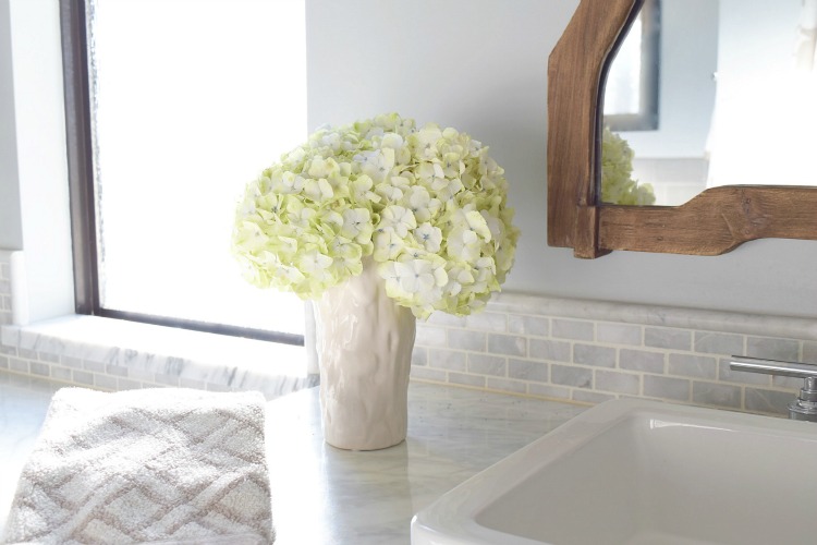 white hydrangeas carrara marble master bath