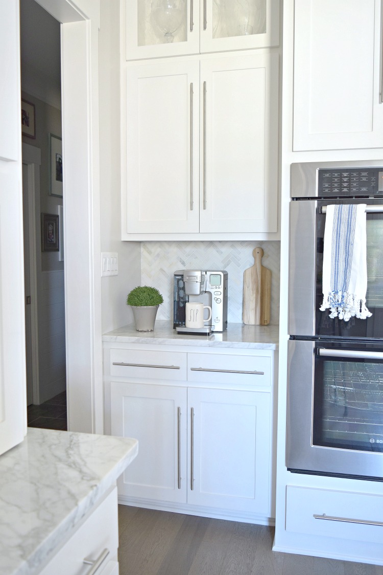 modern white kitchen coffee bar herringbone backsplash Carrara marble countertops