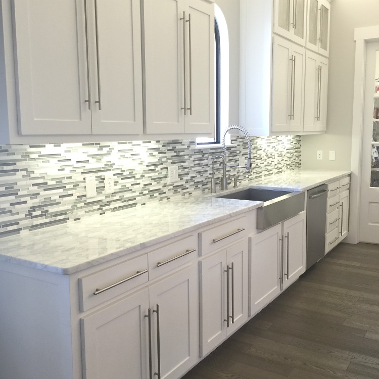 glass and mosaic tile backsplash white kitchen cabinets