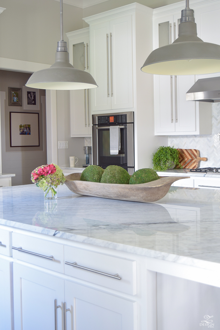 carrara-marble-kitchen-island-bread-bowl-moss-balls-white-farmhouse-kitchen-herringbone-backsplash-2