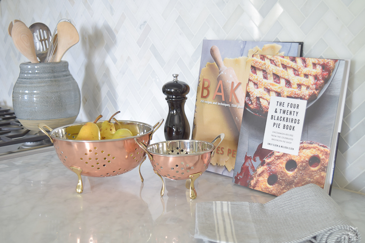 modern-fall-decor-in-the-kitchen-white-carrara-countertops-white-carrara-herringbone-backsplash-brass-pot-1