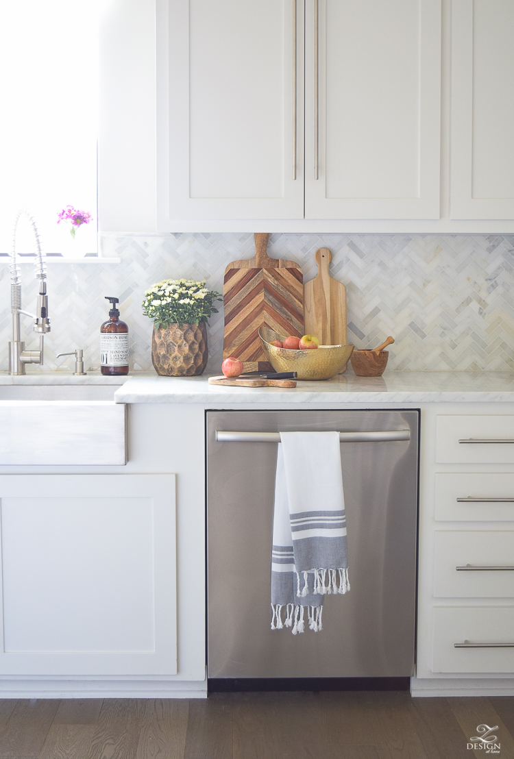 modern-fall-decor-in-the-kitchen-white-carrara-countertops-white-carrara-herringbone-backsplash-brass-pot-3