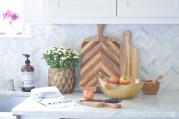 modern-fall-decor-in-the-kitchen-white-carrara-countertops-white-carrara-herringbone-backsplash-brass-pot-white-pumkins-3