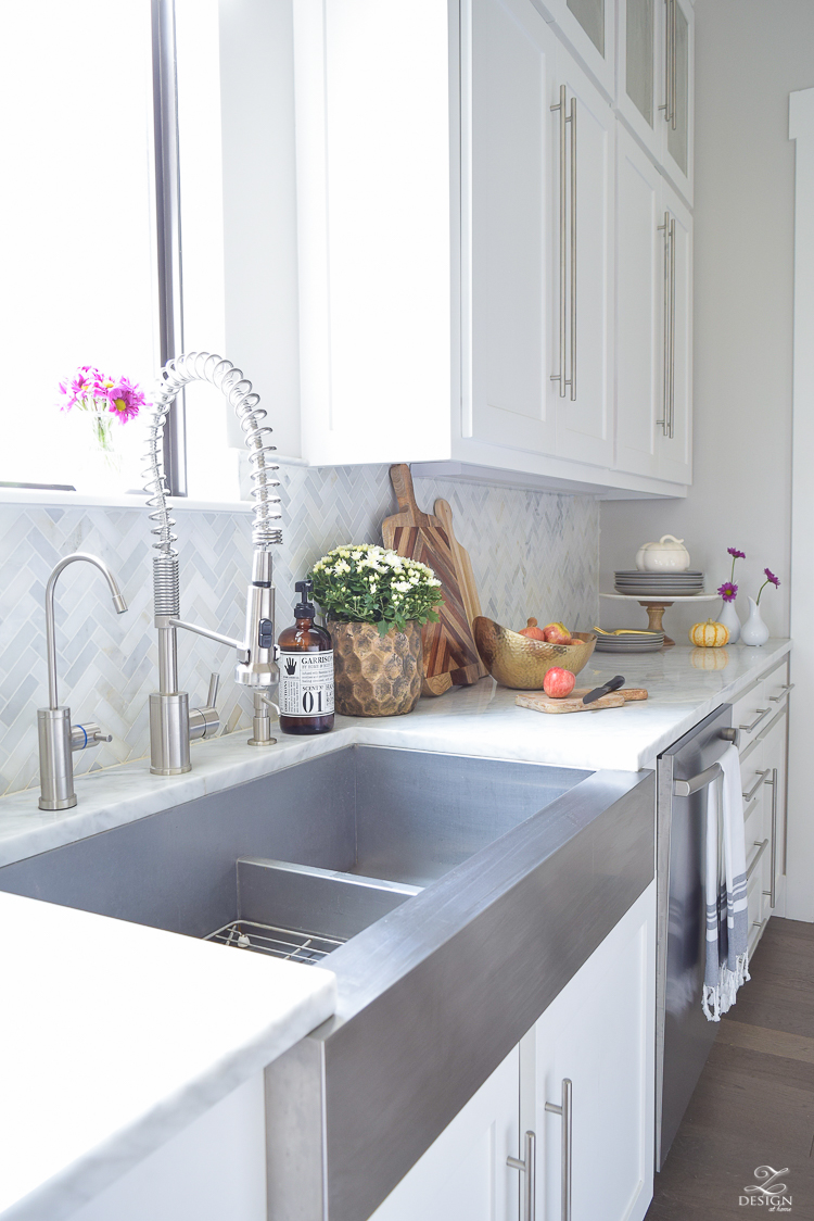 modern-fall-decor-in-the-kitchen-white-carrara-countertops-white-carrara-herringbone-backsplash-brass-pot-white-pumkins-stainless-farmhouse-sink-1