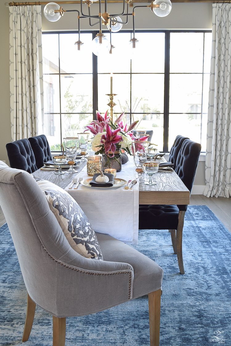 thanksgiving-table-scape-black-velvet-chairs-vintage-inspired-blue-rug-kravet-riad-curtains-gray-washed-dining-table-white-hydrangeas-plum-lillies-1