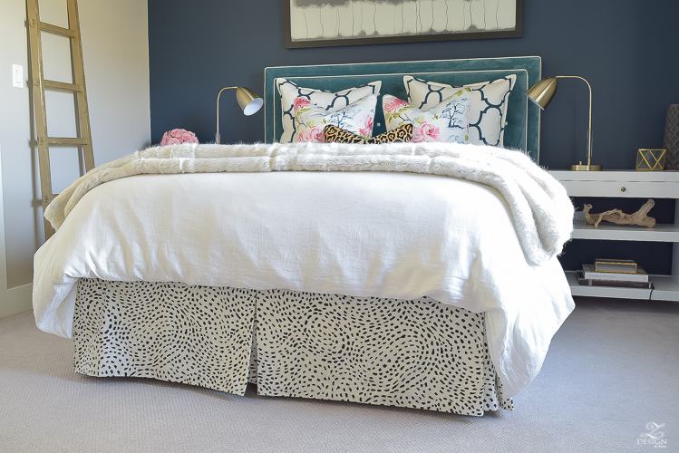 custom-bedskirt-dalmation-fabric-white-faux-fur-throw-benjamin-moore-gentlemans-gray-paint-floral-and-leopard-pillows-white-linen-bedding-brass-lamps-1