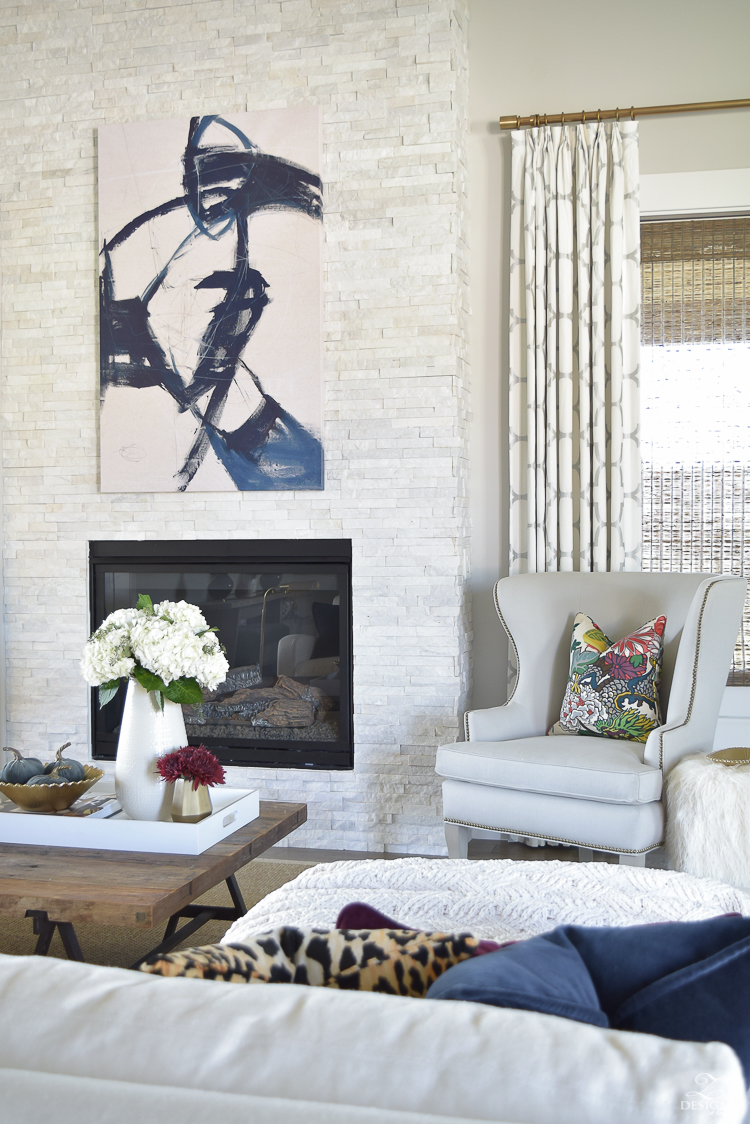 transitoinal-living-room-tour-restoration-hardware-couch-chaing-mia-dragon-fabric-seagrass-rug-navy-abstract-art-white-hydrangeas-fur-stools-4