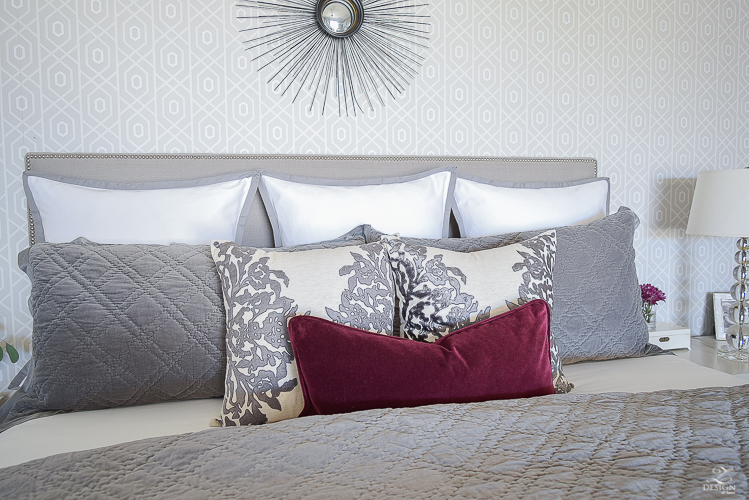 neutral-gray-and-white-bedroom-geometric-wallpaper-gray-nightstands-white-bedding-with-gray-border-gray-velvet-quilt-and-shams-5