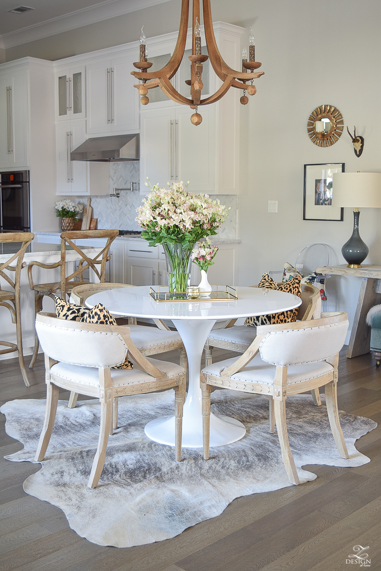 get-the-curl-out-of-cowhide-rug-white-farmhouse-kitchen-white-tulip-table-white-carrara-marble-marble-herringbone-tile-backsplash-3