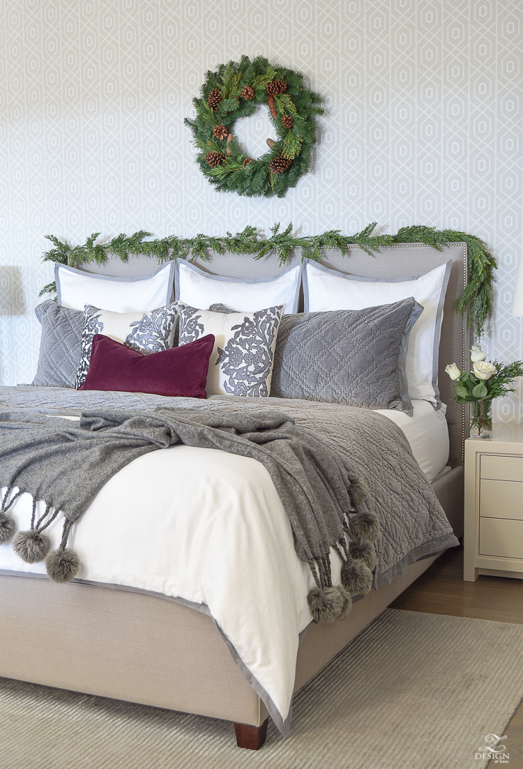 christmas-tour-bedroom-white-bedding-geometric-wallpaper-wreath-and-garland-on-headbaord-pom-pom-throw-upholstered-nailhead-bed-2