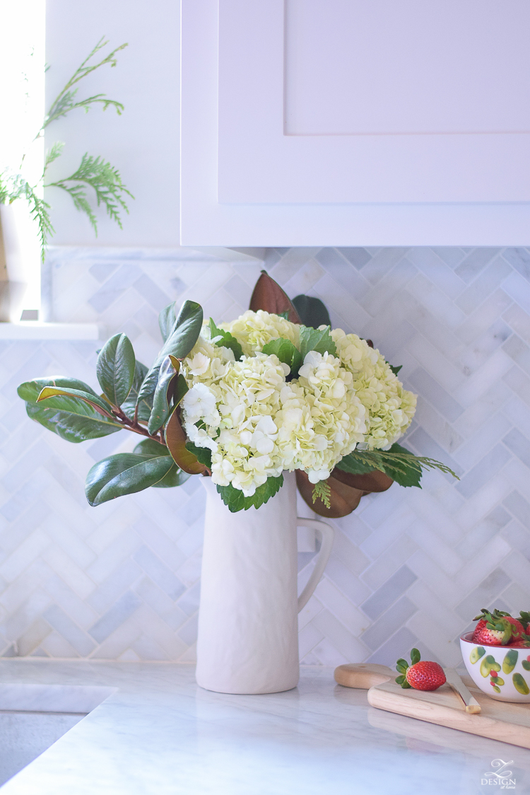 white-modern-farmhouse-kitchen-with-white-carrara-marble-and-white-herringbone-backsplash-christmas-deocr-for-the-kitchen-vintage-barn-pendants-large-dough-bowl-10