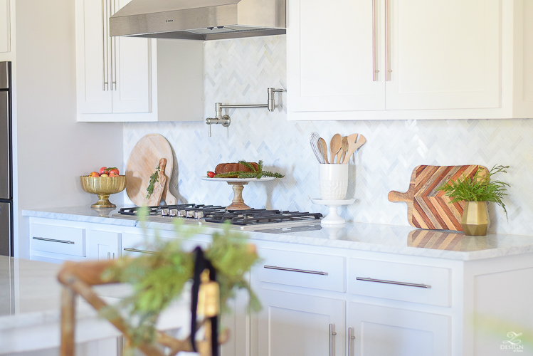 white-modern-farmhouse-kitchen-with-white-carrara-marble-and-white-herringbone-backsplash-christmas-deocr-for-the-kitchen-vintage-barn-pendants-large-dough-bowl-12