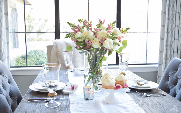 Valentines tablescape crystal heart ornament white fur throw flower arrangement with white roses pink snap dragons white cupcakes white dishes-4