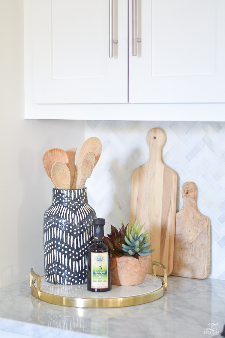 marble and brass tray black and white global inspired vase faux succulents in pot cutting boards white farmhouse kitchen marble herringbone tile backsplash tips for styling the kitchen counters counter top decor