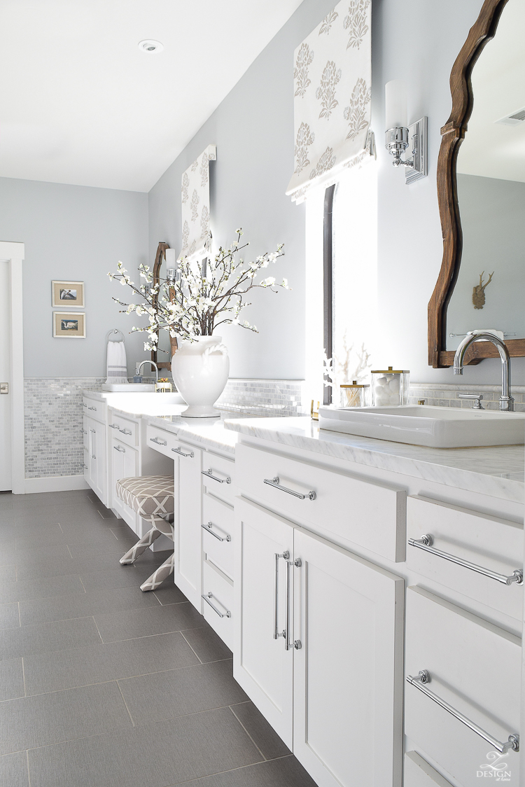 spring bathroom refresh white cabinets faux roman shades brass and marble accessories wooden mirror white carrara marble marble backsplash gray 12 x 24 tile-1