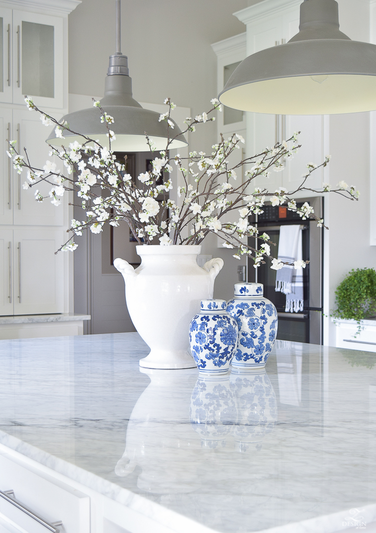 cozy and inviting home with blue and white ginger jars white blossoms white carrar marble white cabinets white farmhouse kitchen-1