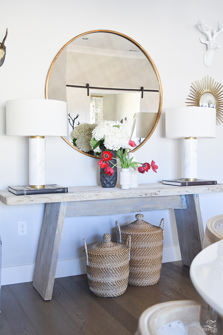 how to make a cozy and inviting home with flowers round gold mirror sw on the rocks modern rustic console table marble and brass lamps baskets under console-3