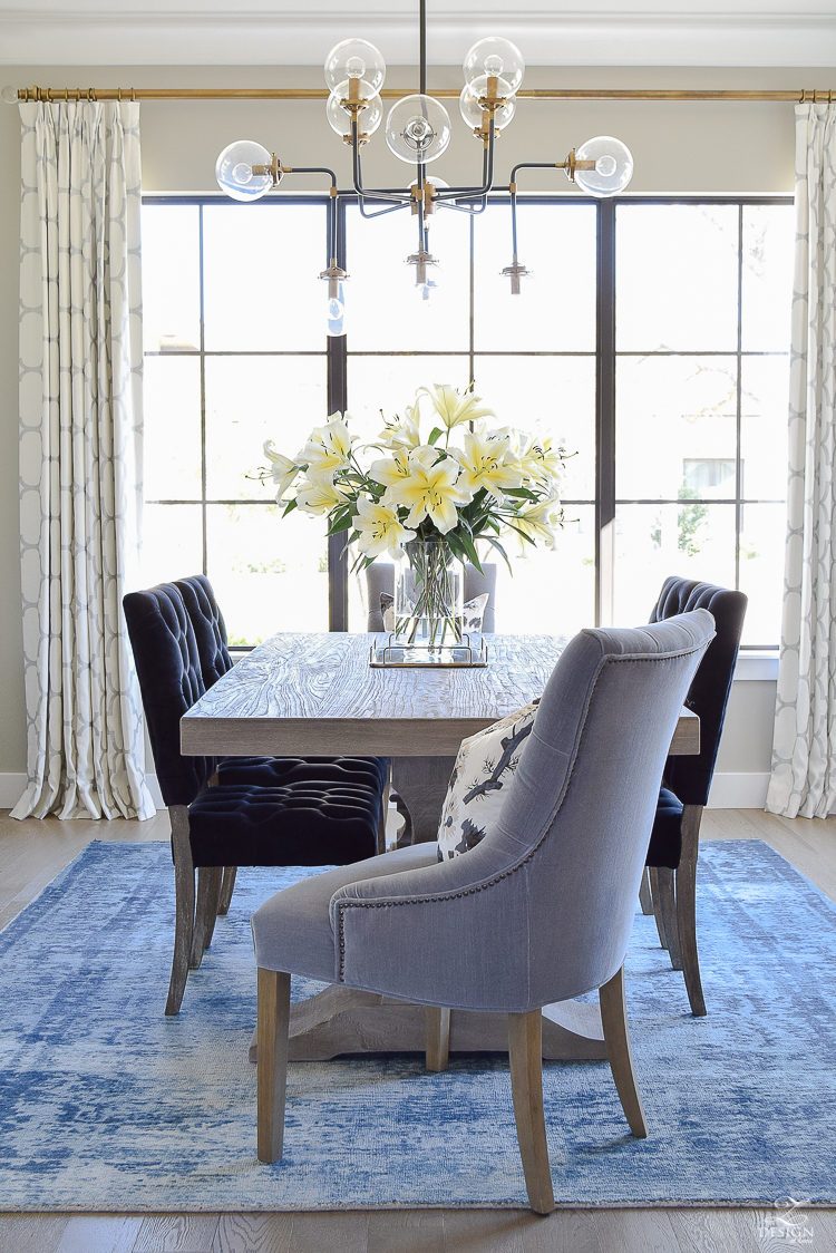 tip to make your home feel cozy and inviting with curtains, flowers and art blue vintage inspired rug black tufted dining chairs kravet riad custom curtains sw mindful gray-1