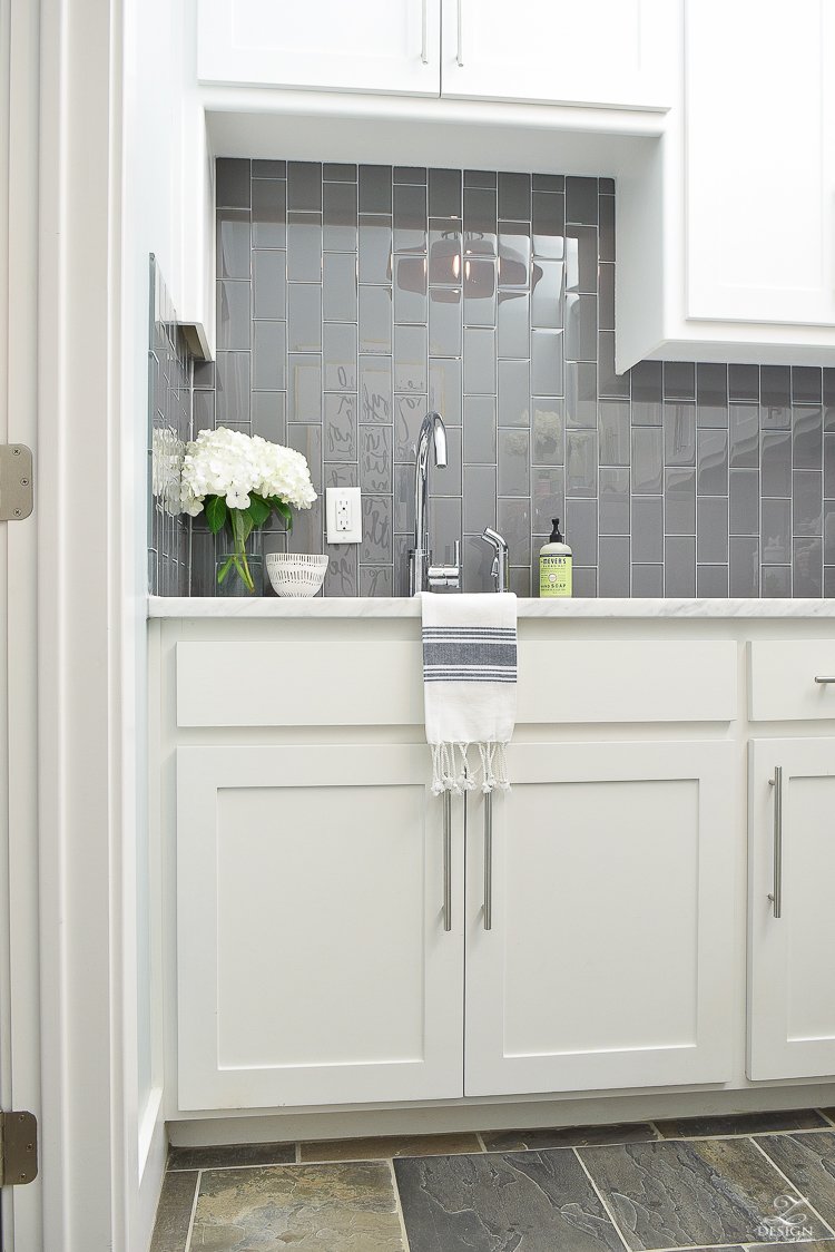 Beautiful laundry room ideas danze kitchen faucet stainless laundry room sink gray subway tile installed vertically white shaker cabinets large stainless bar pulls -6