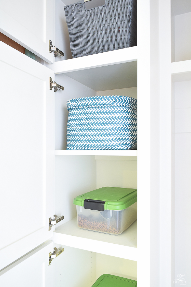 small mud room with pet storage and organization for dog food dog food bowl in drawer white shaker cabinets-3