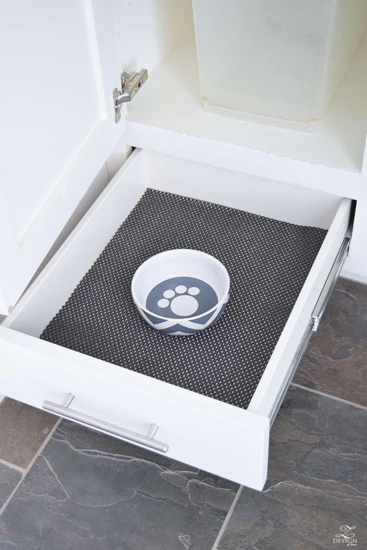 small mud room with pet storage and organization for dog food dog food bowl in drawer white shaker cabinets-5