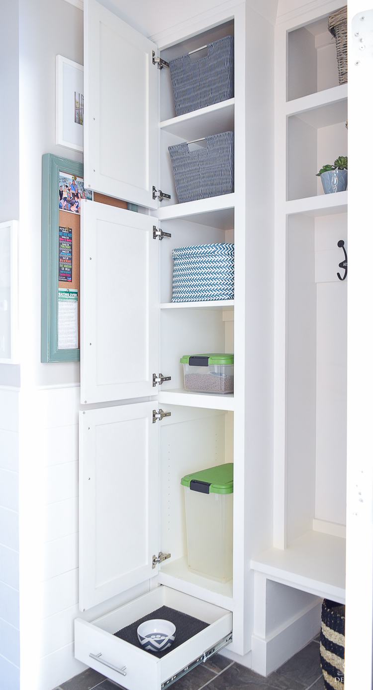 small mud room with pet storage and organization for dog food dog food bowl in drawer white shaker cabinets-7