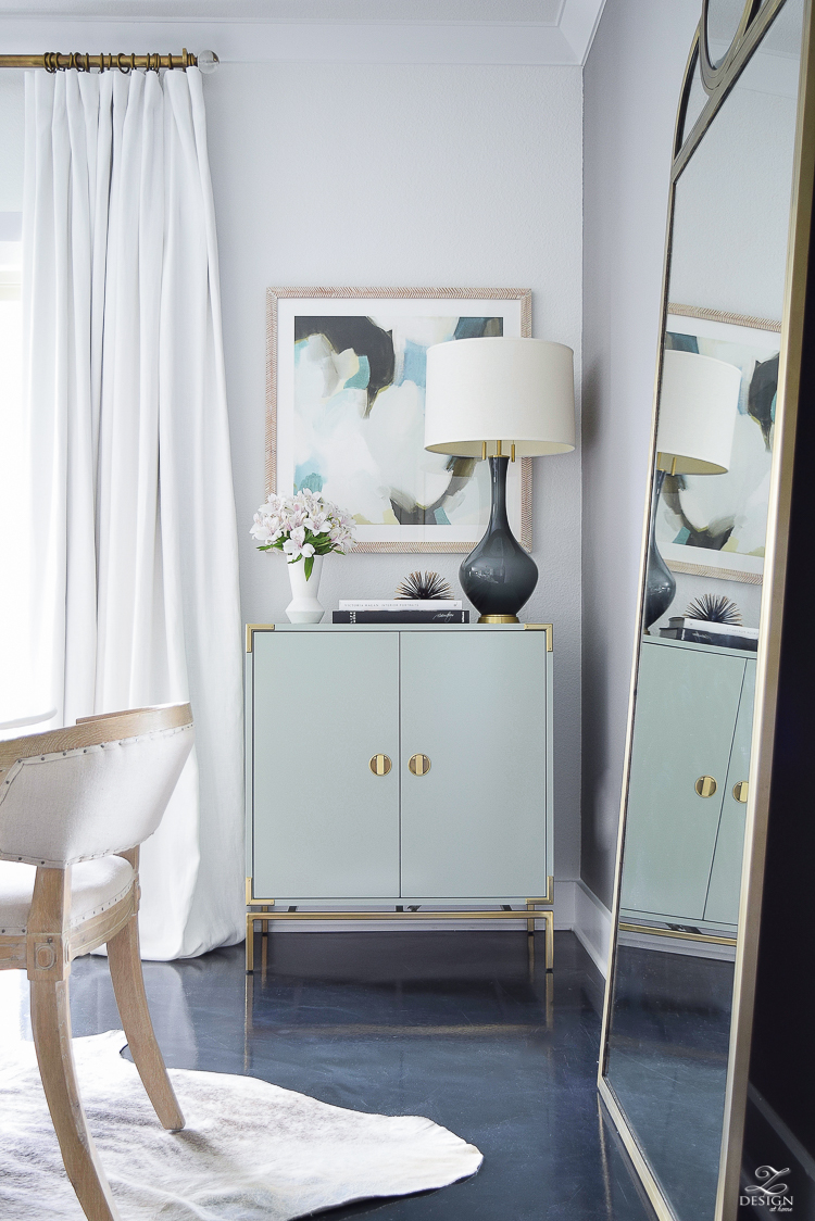 white linen drapes brass rod with crystal ball minted art gray lamp with brass base teal bar cabinet with brass accents black concrete floors console table styling-5