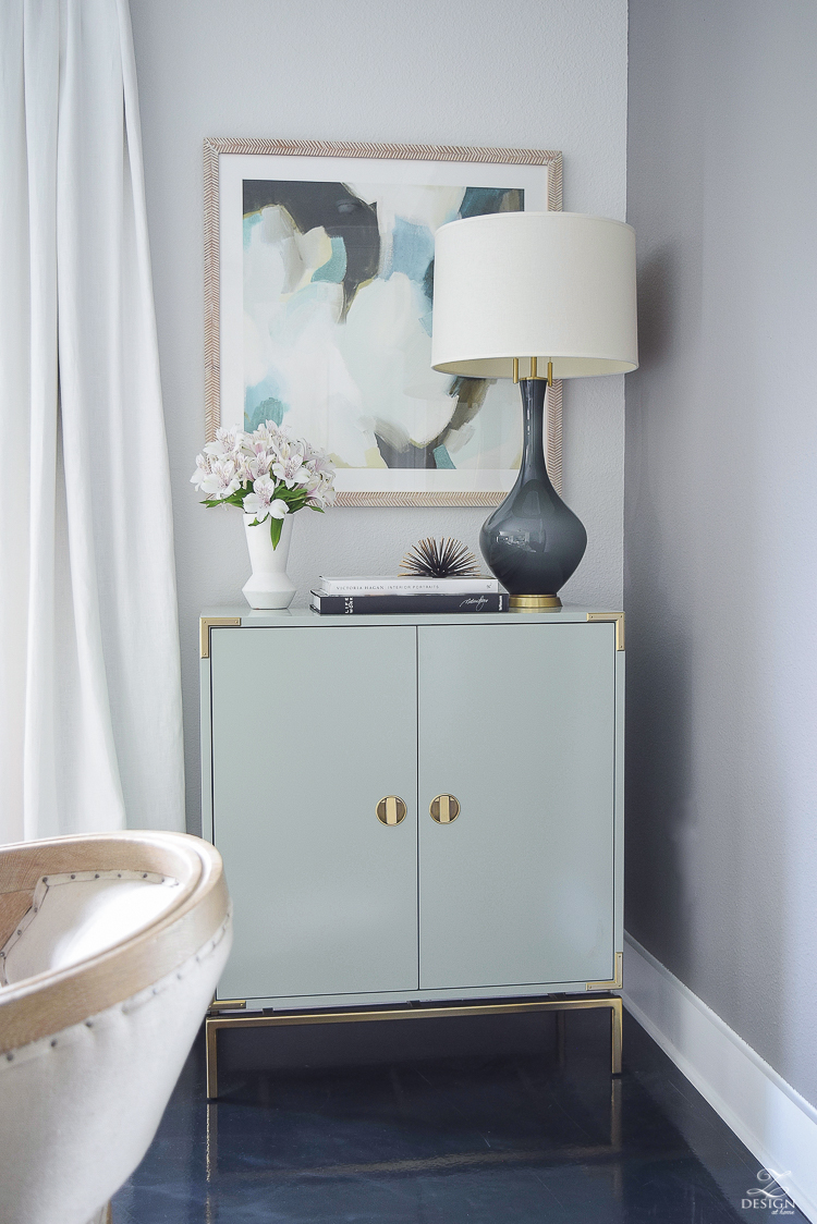 white linen drapes brass rod with crystal ball minted art gray lamp with brass base teal bar cabinet with brass accents black concrete floors console table styling-6