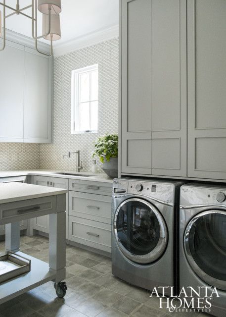 laundry room with gray cabinets and island