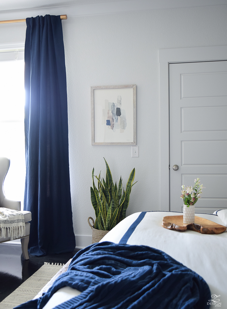 Minted abstract art Bedroom reveal navy linen curtains with blackout liner snake plant in basket navy and white banded bedding transitional style master bedroom-1