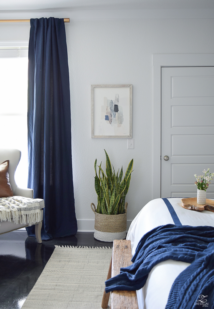 Minted abstract art Bedroom reveal navy linen curtains with blackout liner snake plant in basket navy and white banded bedding transitional style master bedroom-2