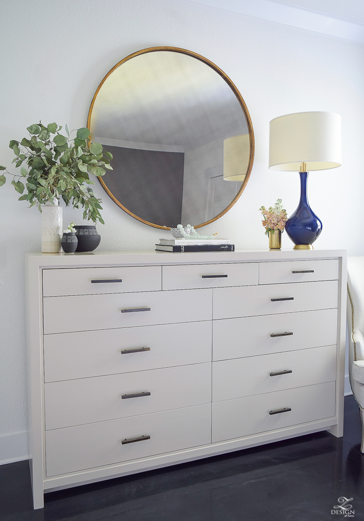 Transitional style master bedroom round gold mirror navy lamp with brass base dresser styling bedroom dresser decor modern gray dresser-5