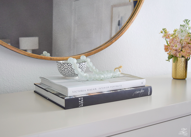 transitional style bedroom decor glass bead strand decorating with books round gold mirror black and white modern vases-2