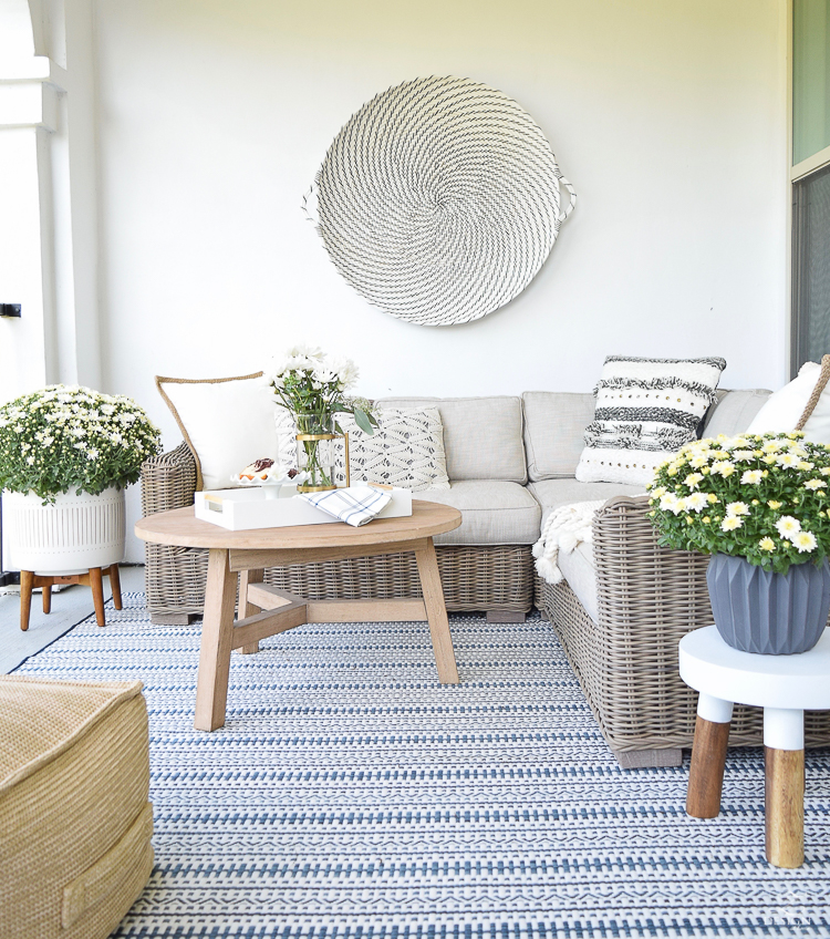 neutral fall patio a stroll thru life fall home tour hanging wall basket blue and white outdoor rug serene patio for fall fall decorating-2