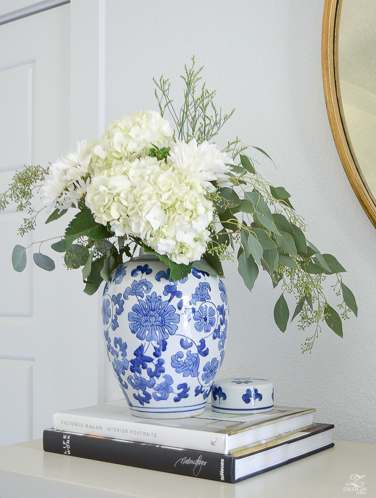 white hydrangeas in a blue chinosserie vase decorating with coffee table books fall flowers with seeded eucalyptus fall decorating-1