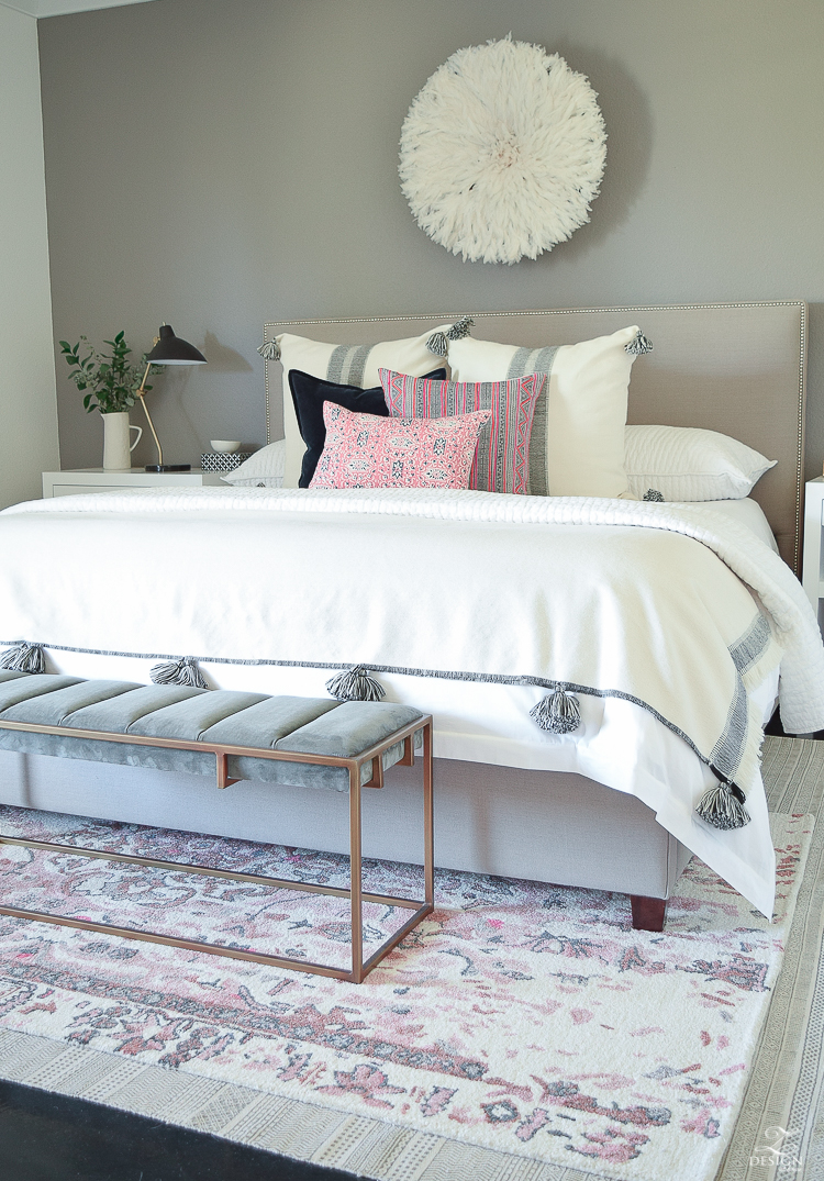 Romantic bedroom with Vintage inspired blush and gray rug plus tips for layering your rugs