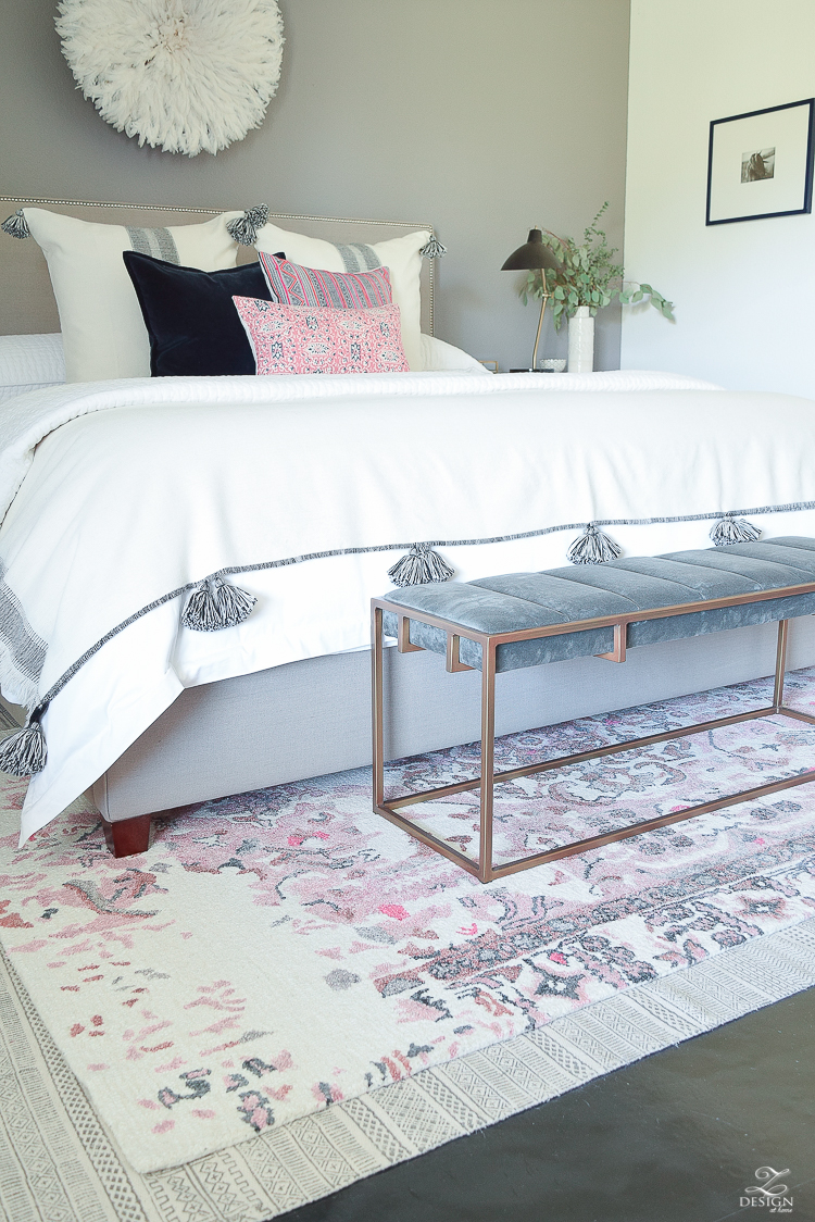 Romantic bedroom with Vintage inspired blush and gray rug plus tips for layering your rugs