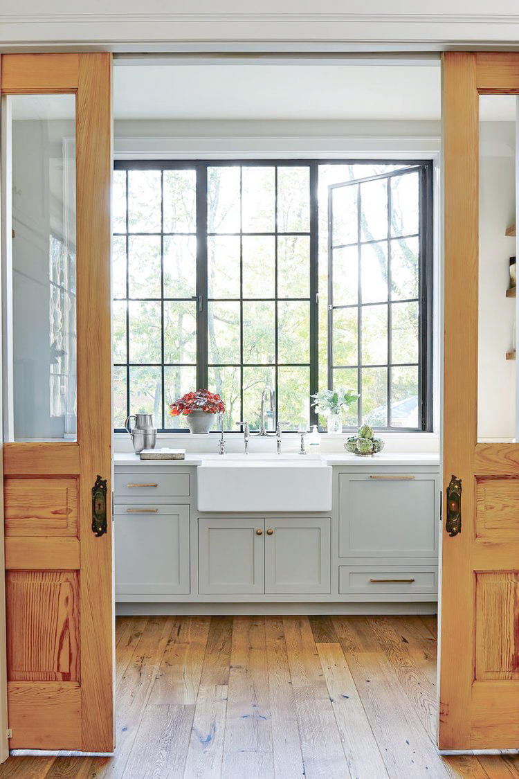 Rachel Holvorson Design sink in front of windows gray cabinets brass hardware steel windows-1