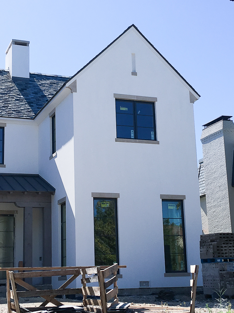 White stucco house with concrete lintels and sills