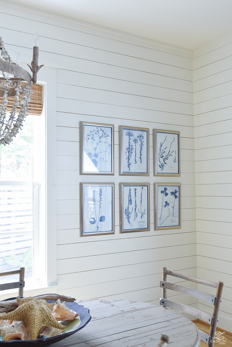 blue and white botanical art prints with silver frame in coastal inspired Florida rental home 