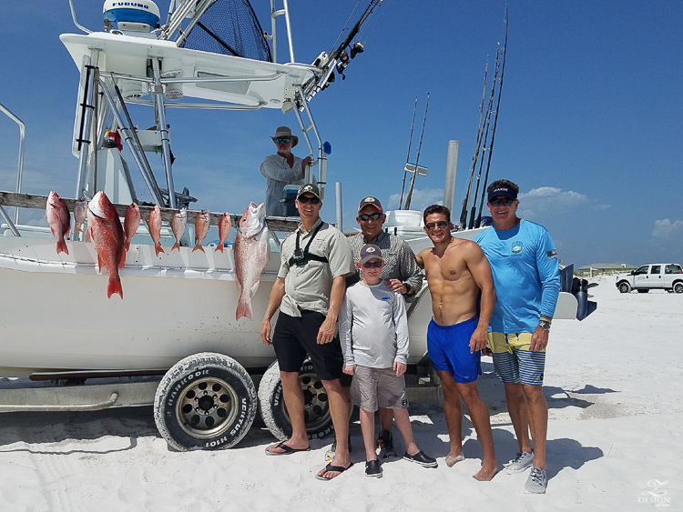 Men on red fish fishing trip in 30A