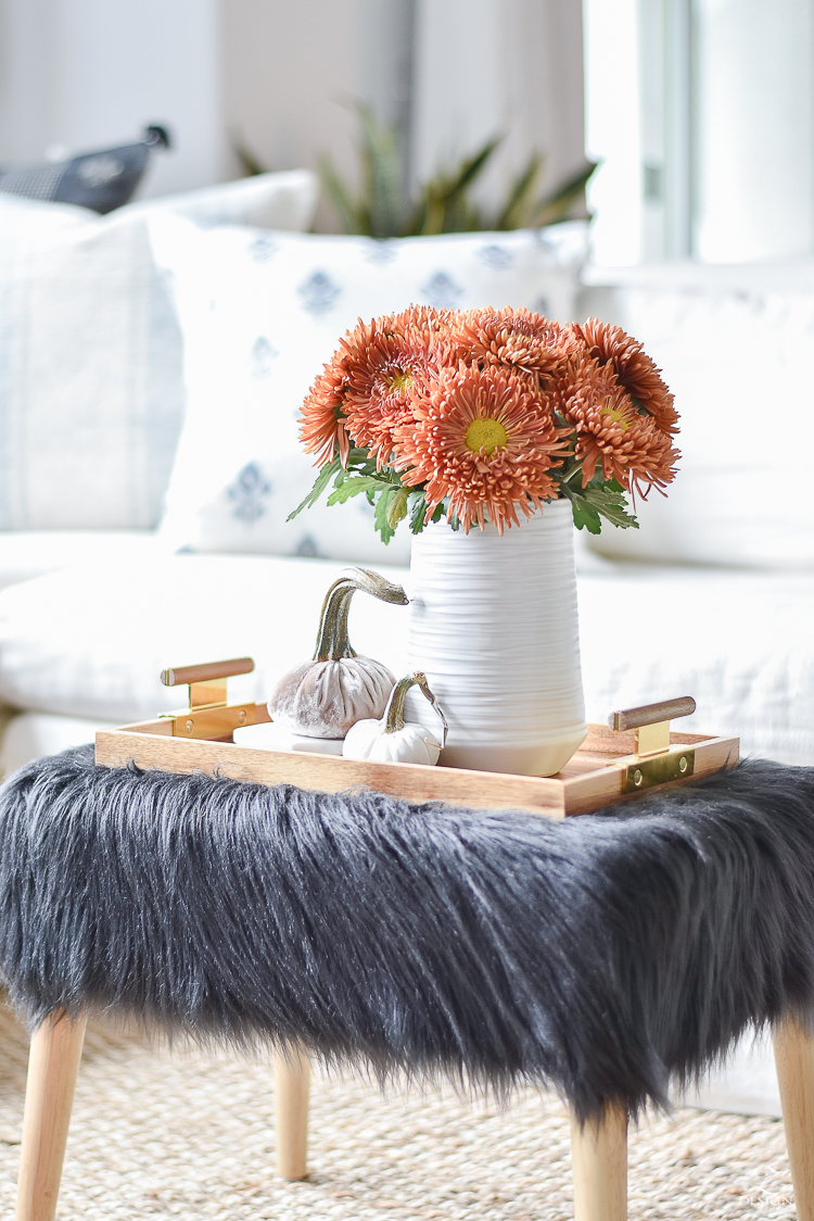 Simple, Modern Fall Decorating Ideas - black fur stool, orange mums, velvet pumpkins