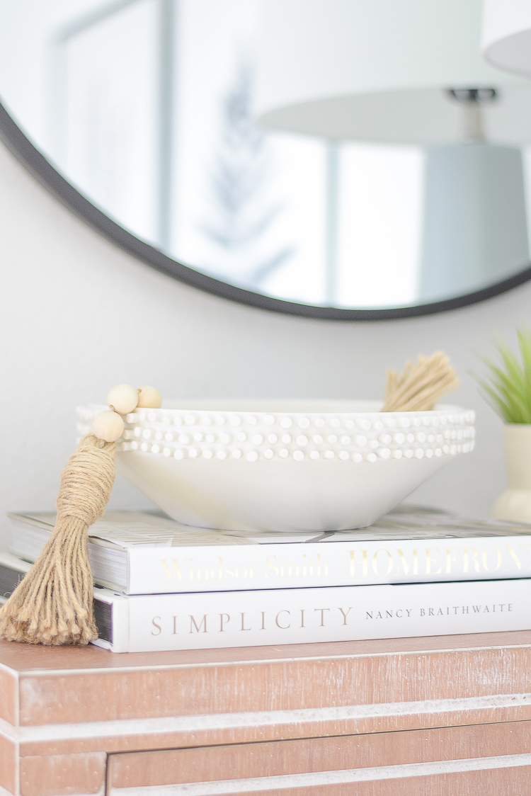 Boho chic dining room reveal - faux succulent in vase, white tufted bowl with tassel bead strand