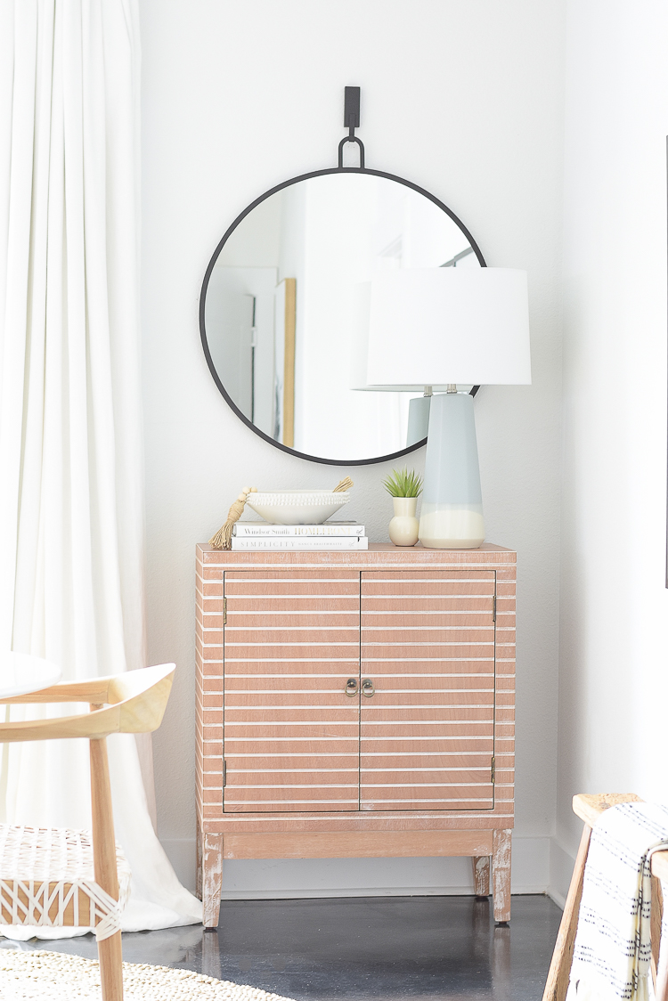 Boho chic dining room reveal - modern bar cabinet, round black mirror