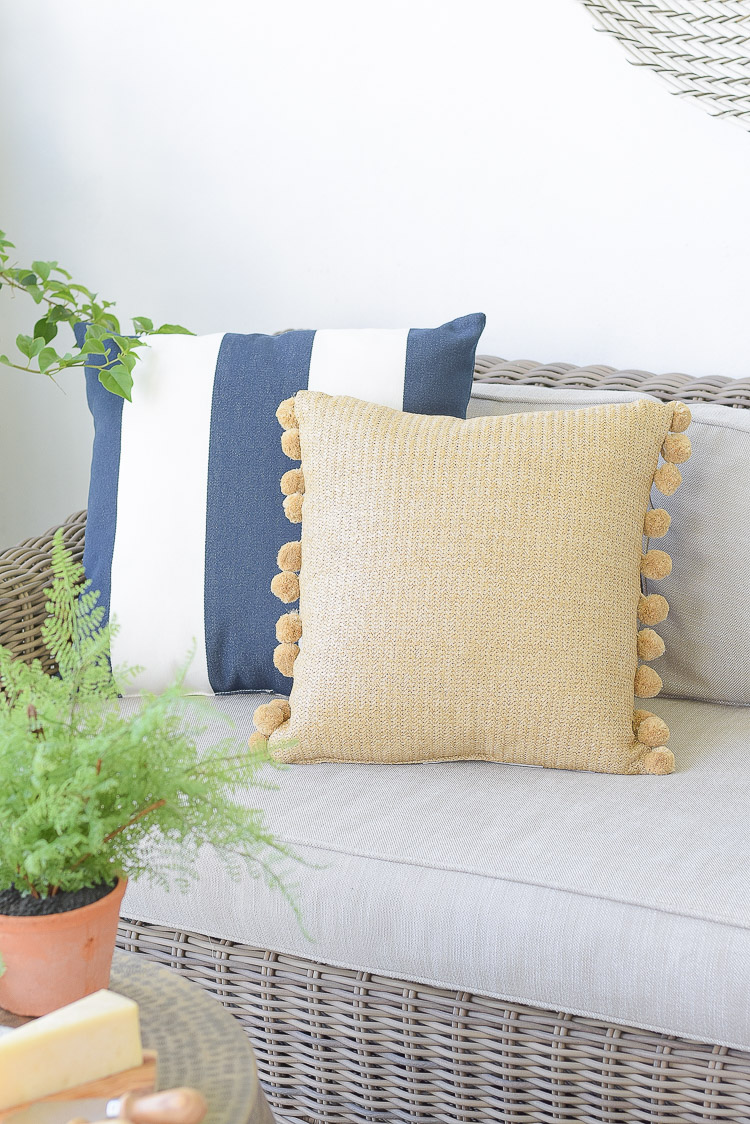 The best sustainable home decor products for outdoor - pom pom pillow, navy white stripe pillow