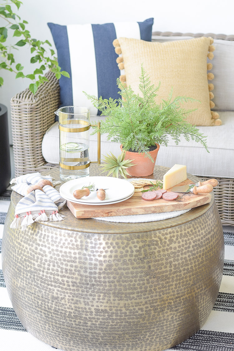 Outdoor sustainably sourced home decor items - cheese board, faux ferns, tassel napkins, olive wood dining accessories 