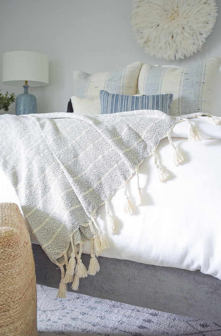 4 Subtle Ways To Add Coastal Decor To Your Home - Coastal Inspired Bedroom - neutral tassel throw with fringe