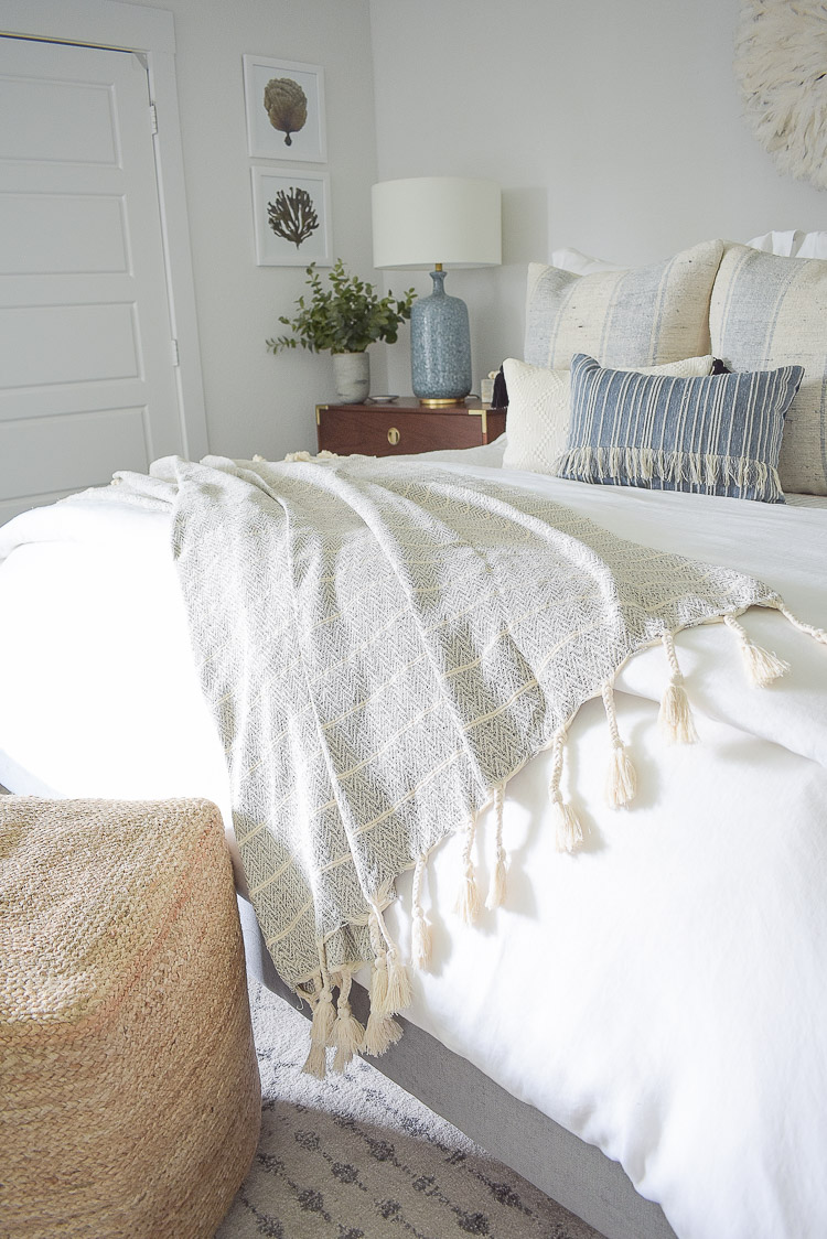 4 Subtle Ways To Add Coastal Decor To Your Home - Coastal Inspired Bedroom - neutral tassel throw with chevron pattern