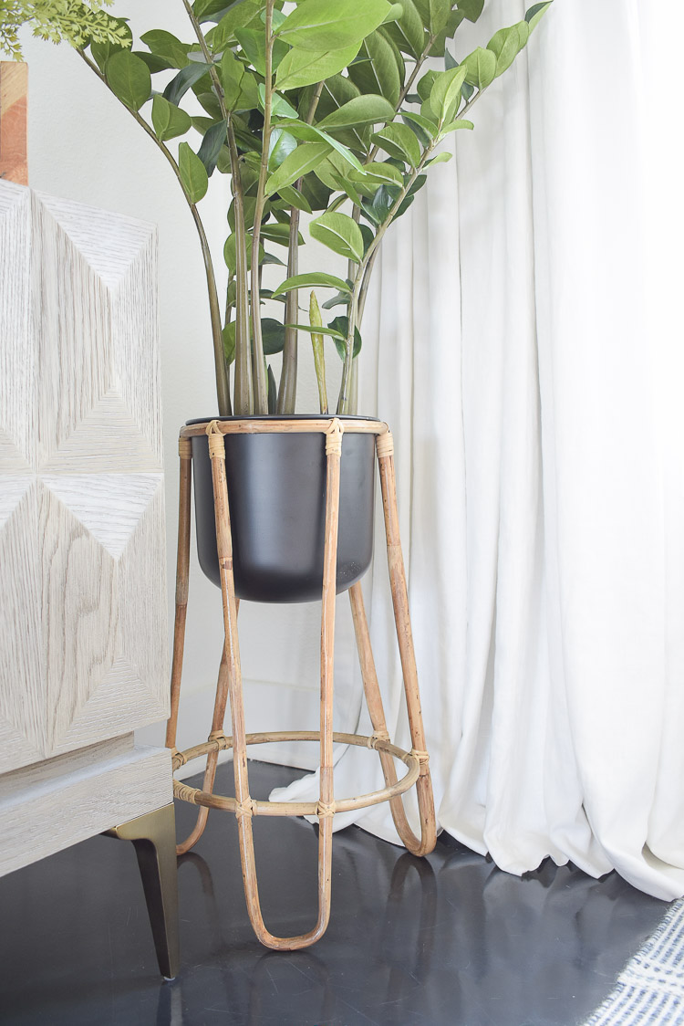 Small space, big style solutions - rattan plant stand with black pot