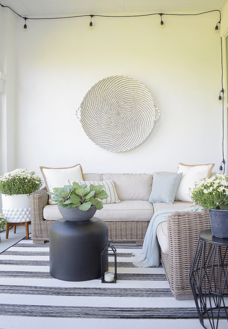 A Cozy Modern Fall Patio Tour - string lights, cement planter, white dotted planter 